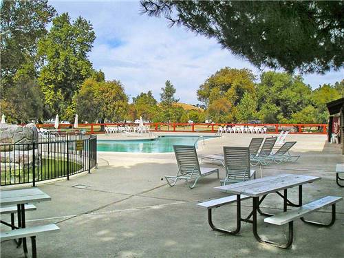 Swimming pool with outdoor seating at THOUSAND TRAILS SAN BENITO