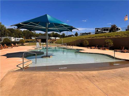 A poolside view of the large outdoor pool at CLEMSON RV PARK AT THE GROVE