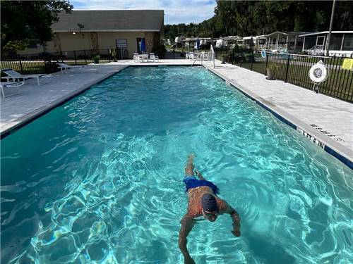 A man swimming in the pool at DADE CITY RESORT