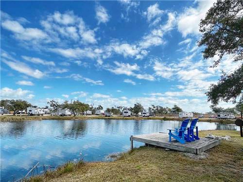 A dock with chairs overlooking the water at QUILLY'S BIG FISH RV PARK
