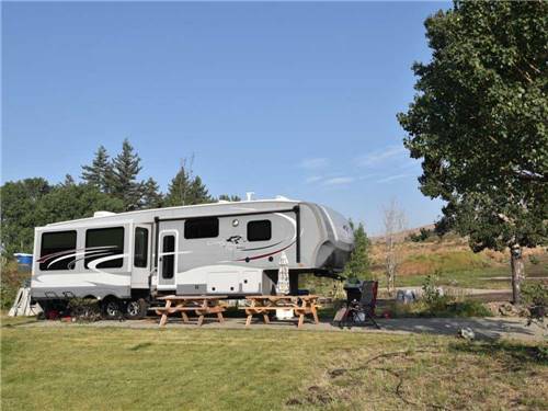 Fifth wheel parked at campsite at SUMMIT RV RESORT