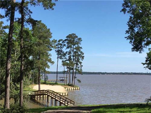 Walking path over the lake to the pier at THE PRESERVE RV PARK