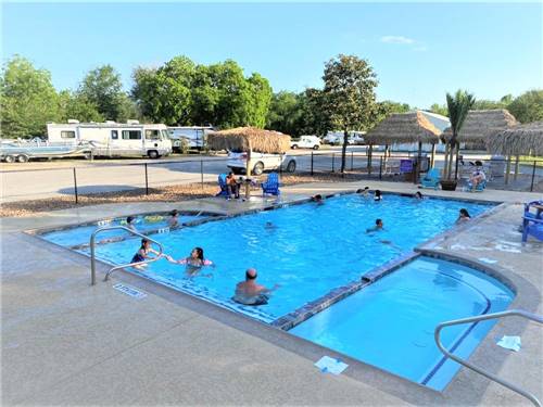 Families enjoying the swimming pool at LAKE CONROE RV CAMPGROUND BY RJOURNEY