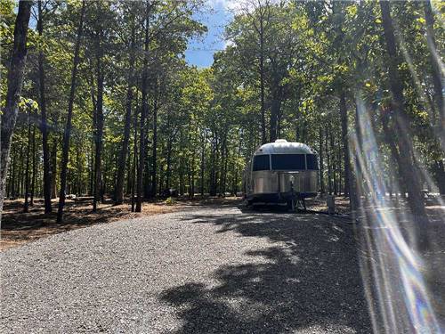 An Airstream parked in a gravel site at CLOUD CAMP