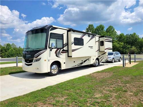 A motorhome parked in a paved site at TIFTON OVERNIGHT RV