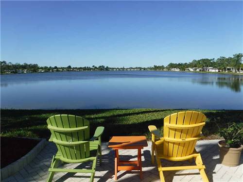 Chairs overlooking the water at CRYSTAL LAKE RV RESORT