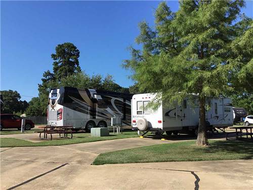 A motorhome and trailer at SHADY PINES RV PARK