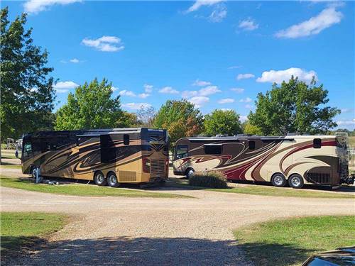 Two motorhomes parked in gravel sites at CANTON I-20 RV PARK