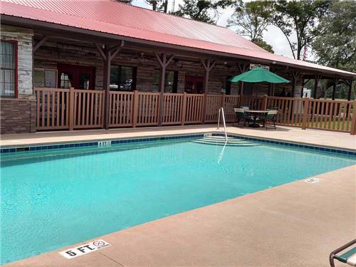 Swimming pool and deck area at WILD FRONTIER RV RESORT
