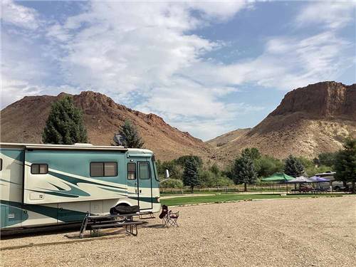 A motorhome in a gravel RV site at CHALLIS GOLF COURSE RV PARK