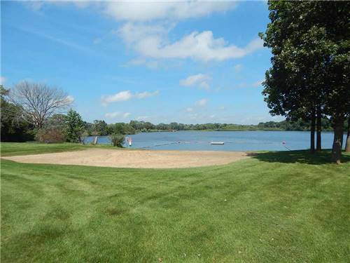A view of the beach and grass at LAKESHORE RV RESORT & CAMPGROUND