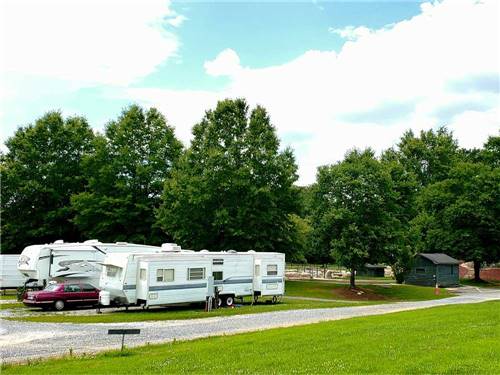 Trailers camping with grassy area at RIVERSIDE GOLF & RV PARK