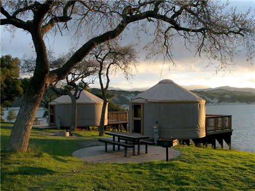 Yurts with balconies and picnic tables at CACHUMA LAKE CAMPGROUND