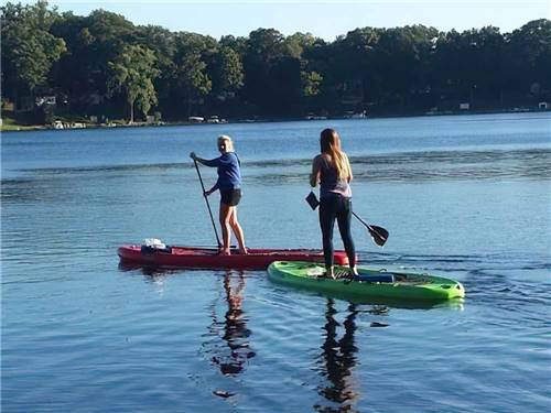 A couple of women on standing paddle boards at FULLER'S RESORT & CAMPGROUND ON CLEAR LAKE