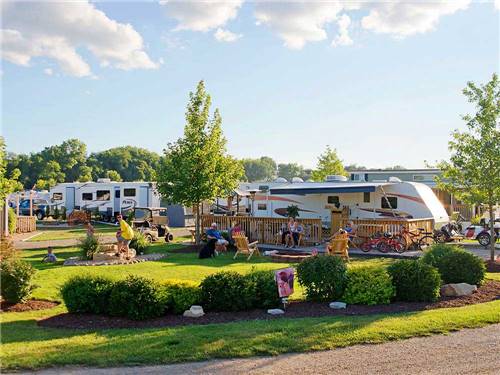 Trailers camping with people outside on sunny day at O'CONNELL'S RV CAMPGROUND