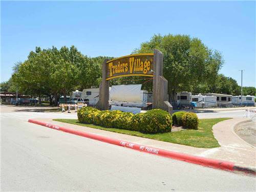Entrance sign leading into park at TRADERS VILLAGE RV PARK