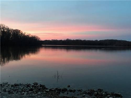 A view of the lake at sunset at PERRYVILLE RV RESORT BY RJOURNEY