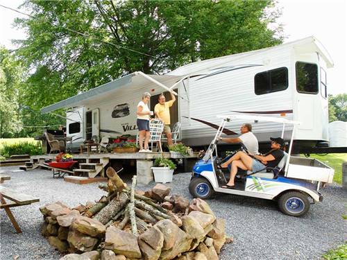 People talking at an RV campsite at HICKORY RUN CAMPGROUND