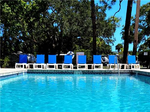 Lounge chairs around the swimming pool at VERO BEACH KAMP