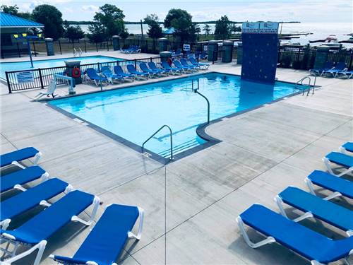 Swimming pool with blue lounge chairs at QUINTE'S ISLE CAMPARK