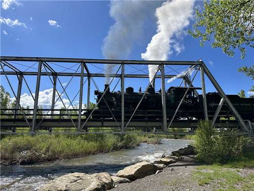 A black train crossing over the river nearby at RIO CHAMA RV PARK