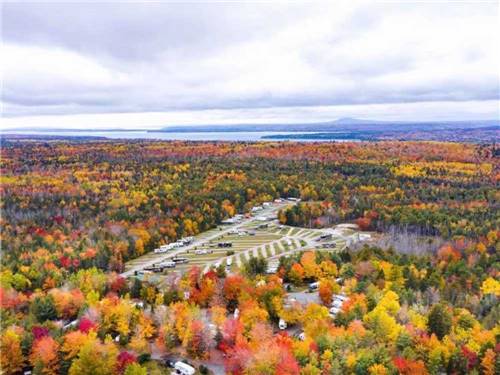 An aerial view of the campground surrounded by colorful fall trees at TIMBERLAND ACRES RV PARK