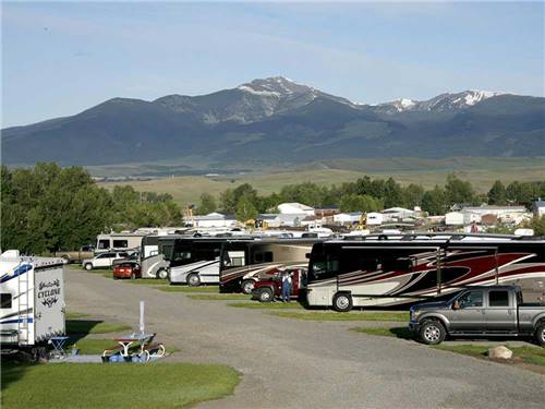 Snowcapped mountains and RVs camping at INDIAN CREEK RV PARK & CAMPGROUND