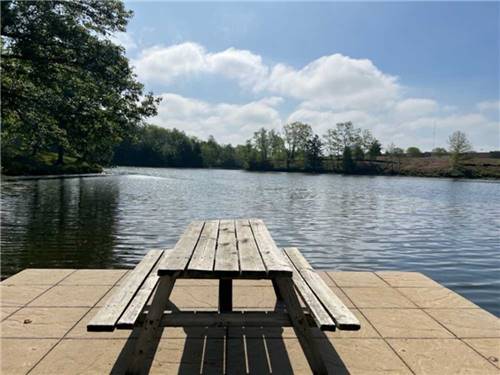 A picnic bench on the dock at CAMP LAKEWOOD CAMPGROUND