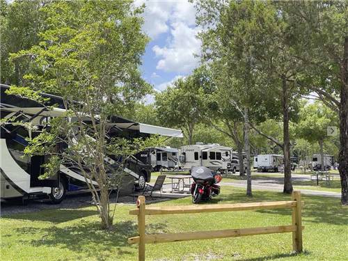 A motorcycle next to a motorhome at STAGECOACH RV PARK