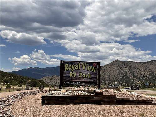 Royal View RV Park sign against rugged mountains at ROYAL VIEW RV PARK