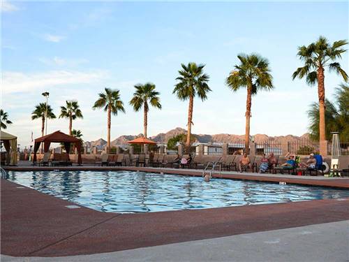 Swimming pool with outdoor seating at FORTUNA DE ORO RV RESORT