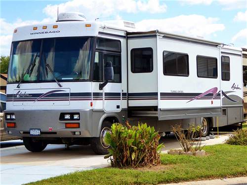 A motorhome parked on-site at CASA DEL VALLE RV RESORT