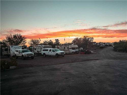 A view of trucks and trailers parked in back ins at AJO HEIGHTS RV PARK