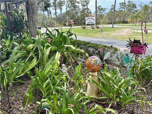 Figurines in the flowerbed by the entrance at SEBRING GARDENS RV COMMUNITY