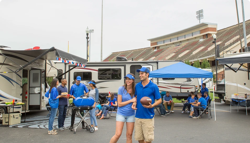 A couple enjoying game day by their RV