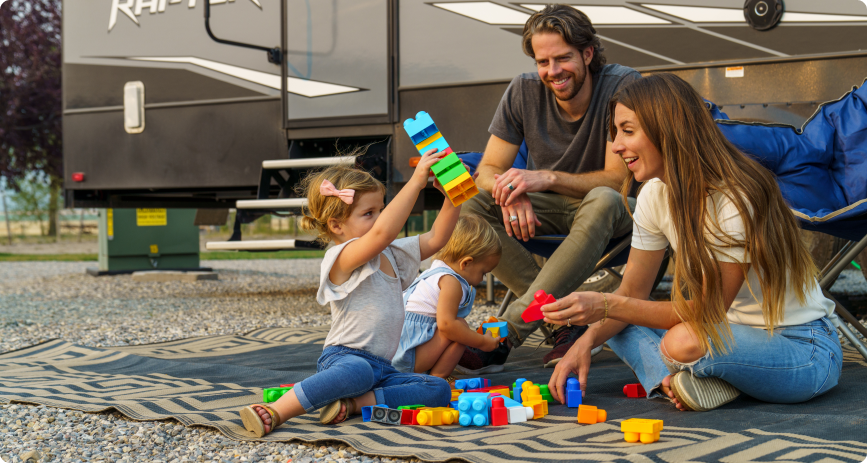 Parents overjoyed watching their kids playing with blocks on the sand 