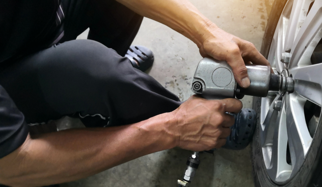 Person fixing a vehicle wheel