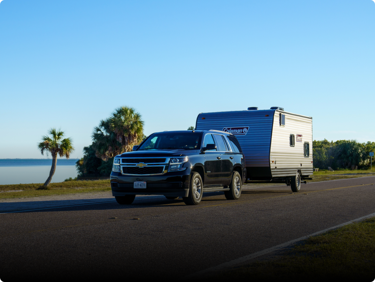 Travel Trailer on the road beside lake view