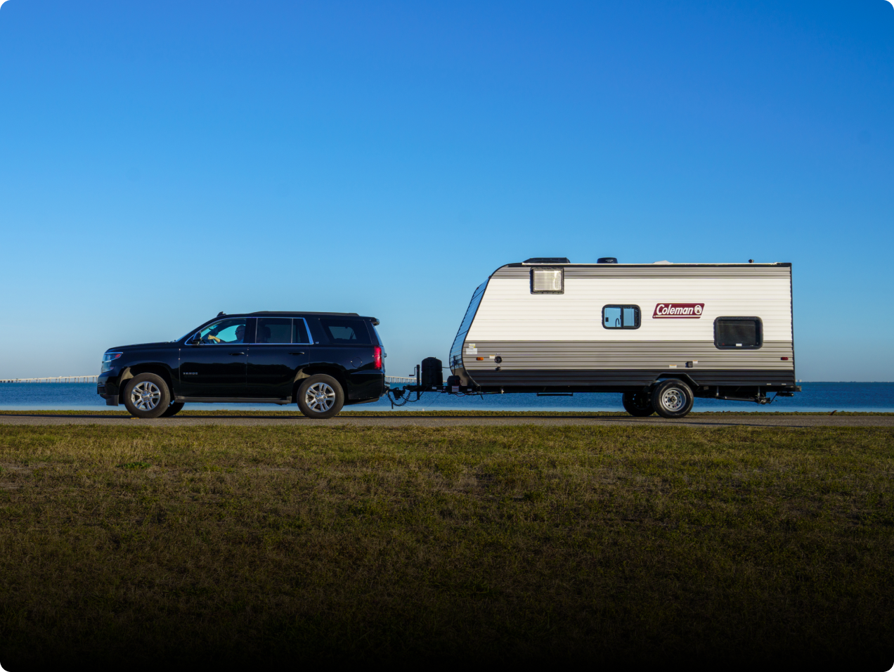Travel Trailer parked beside lake view