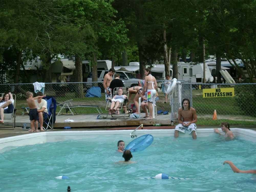 Guests enjoying the swimming pool at GREEN ACRES FAMILY CAMPGROUND