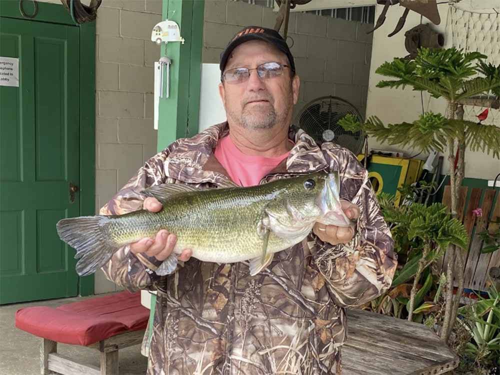 A man holding the fish he caught at GREEN ACRES FAMILY CAMPGROUND