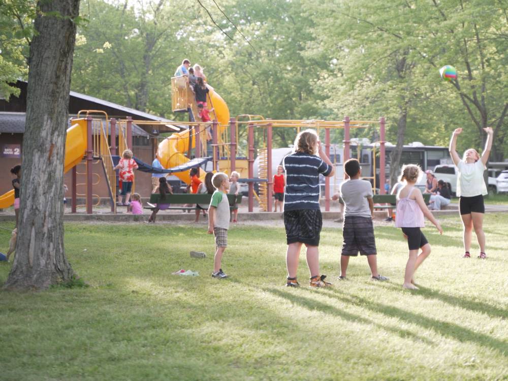 Kids playing with a ball near the playground at Indiana Beach Campground