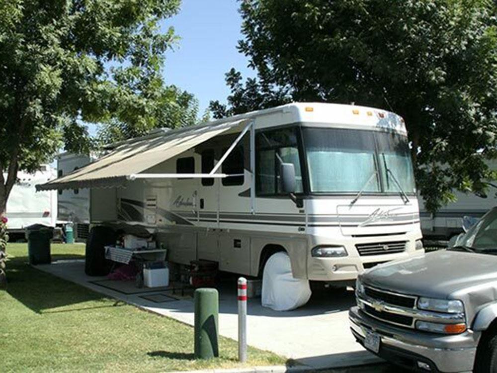 A motorhome parked in a concrete site at COUNTRY MANOR RV & MH COMMUNITY