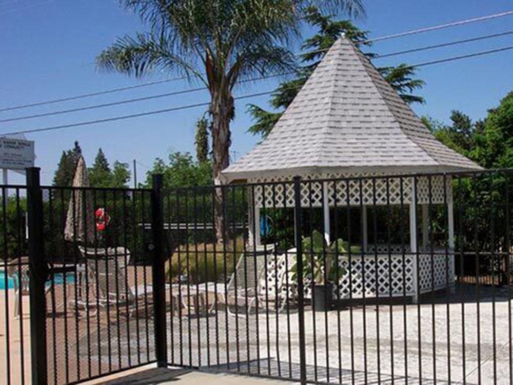 A gazebo in the swimming pool area at COUNTRY MANOR RV & MH COMMUNITY