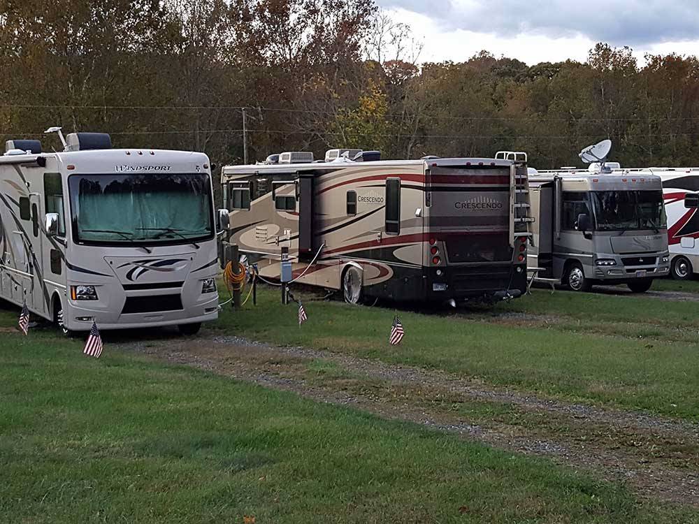 A row of motorhomes in grassy RV sites at GREENVILLE FARM FAMILY CAMPGROUND
