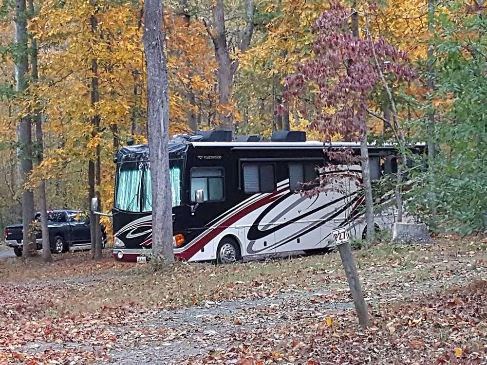 A motorhome under trees at GREENVILLE FARM FAMILY CAMPGROUND
