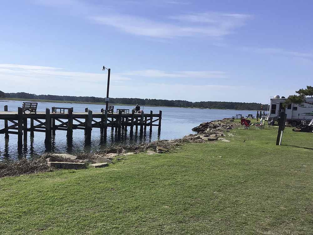 An empty pier with RV sites along the water at TOM'S COVE PARK