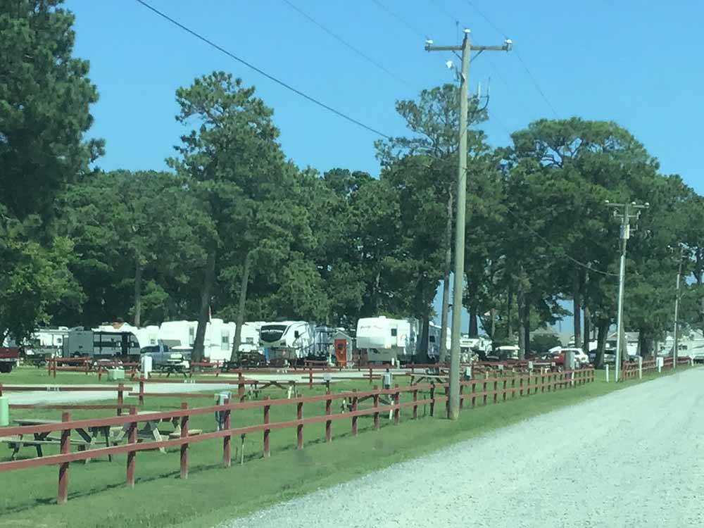 RVs parked at campsites near main road at TOM'S COVE PARK