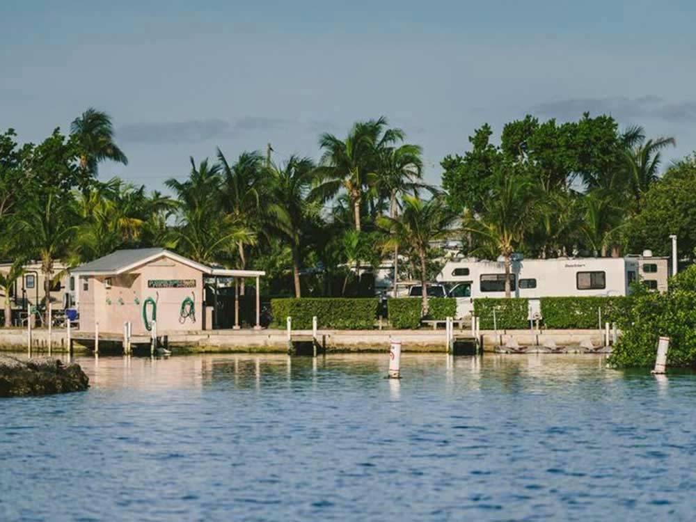 Little pink boathouse on lake with motorhomes nearby at BOYD'S KEY WEST CAMPGROUND