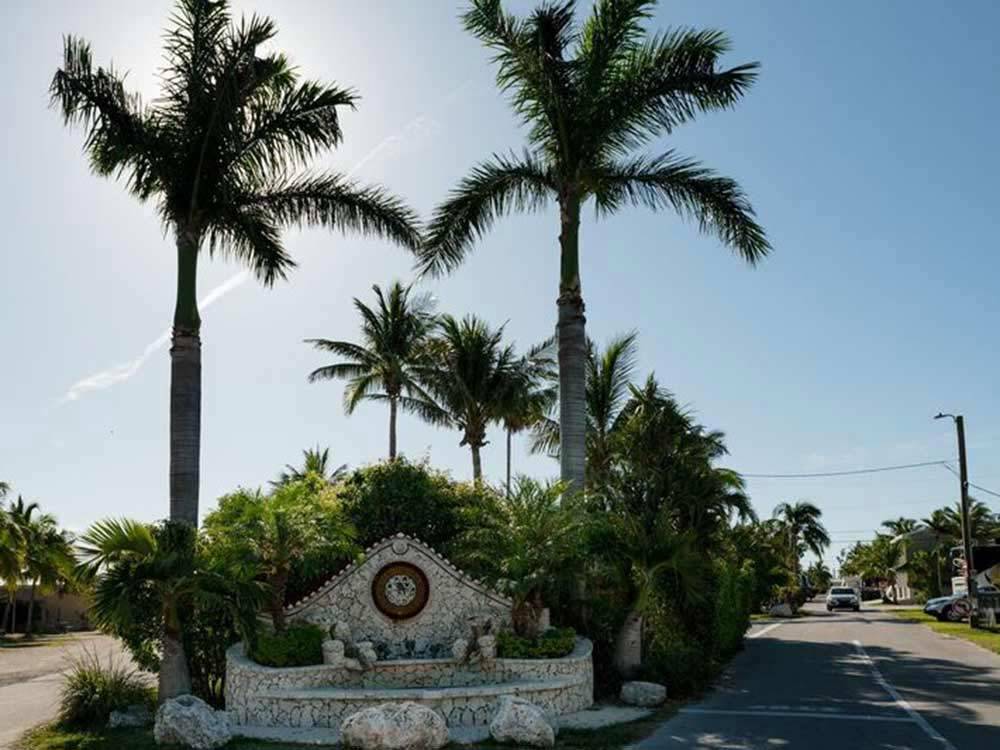White stone front entrance fountain surrounded by palm trees at BOYD'S KEY WEST CAMPGROUND